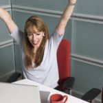 woman cheering at desk